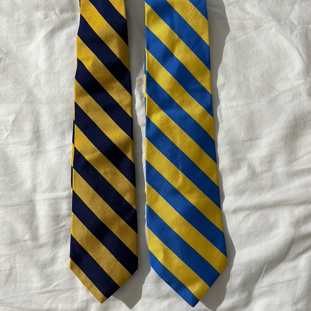 A lot of two preppy, yellow and blue J.Crew ties